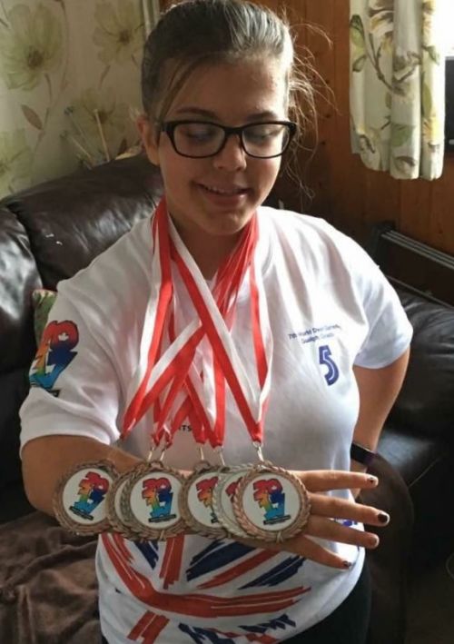 Abi proudly showing off her medals